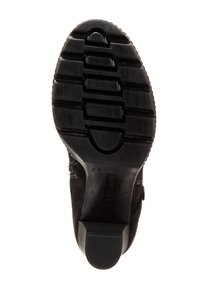 Semelle de botte noire jusqu'aux chevilles avec une surface en caoutchouc texturé à rainures horizontales et un talon bloc. Comprend le nom de la marque "Tamaris" en relief.