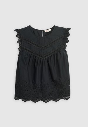 Črna brezrokavnik z obrobljenim čipkastim robom, teksturiranim trupom in očesnimi podrobnostmi na dnu, z režo na hrbtu.