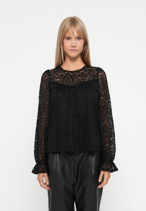 Black lace blouse with long sleeves, round neckline, and ruffled cuffs. Features intricate floral patterns and a loose, relaxed fit.