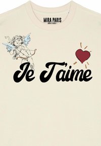 Felpa crema con un cherubino stampato con ali blu, il testo "Je T'aime" in grassetto nero e una grafica di un cuore rosso.