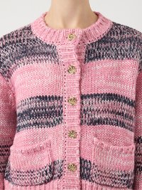 Knitted cardigan featuring pink and navy stripes, ribbed collar, decorative gold buttons, and two front pockets. Textured yarn shows depth.