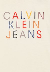 Calvin Klein Jeans LOGO GRAPHIC UNISEX - Marškinėliai su spaudiniu - ivory