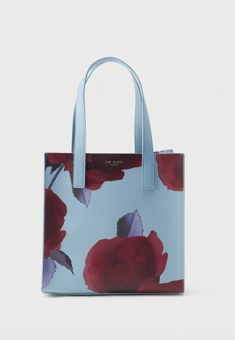 Blue tote bag featuring a floral pattern with red roses and green leaves, smooth synthetic material, rectangular shape, and two top handles.