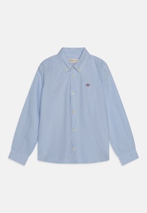 Chemise bleu clair à manches longues avec boutons, col boutonné et petit logo brodé sur le côté gauche de la poitrine.