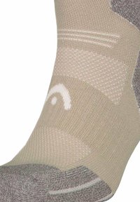 Beige och grå sportstrumpa med texturerade mönster, som har en åtsittande passform och en vit logotypdetalj. Tillverkad av andningsbart material.