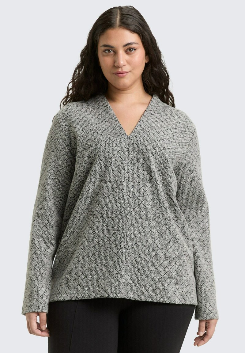 Gray patterned long-sleeve top with a V-neck, loose fit, and textured fabric. The design features a geometric pattern throughout.