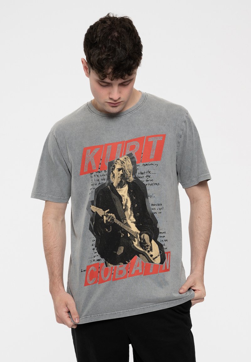 Gray cotton t-shirt featuring a large graphic print of a musician holding a guitar, with red text reading "KURT" and "COBAIN."
