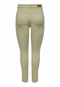 Hubené denimové džíny ve světlé béžové barvě, s pasem střední výšky, zadními kapsami a hladkou texturou. Kožená etiketa na zadní straně.