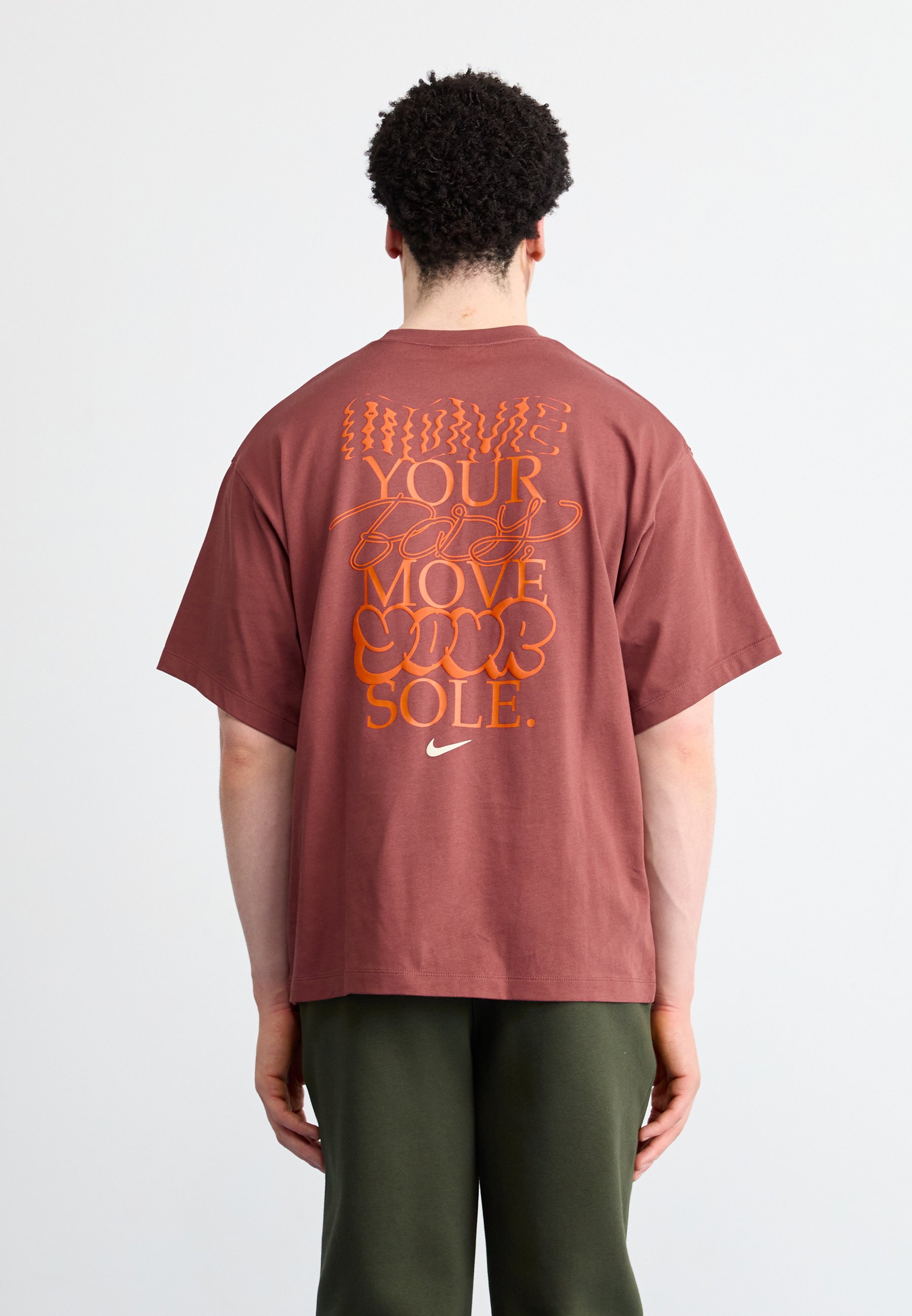 brown and orange nike shirt