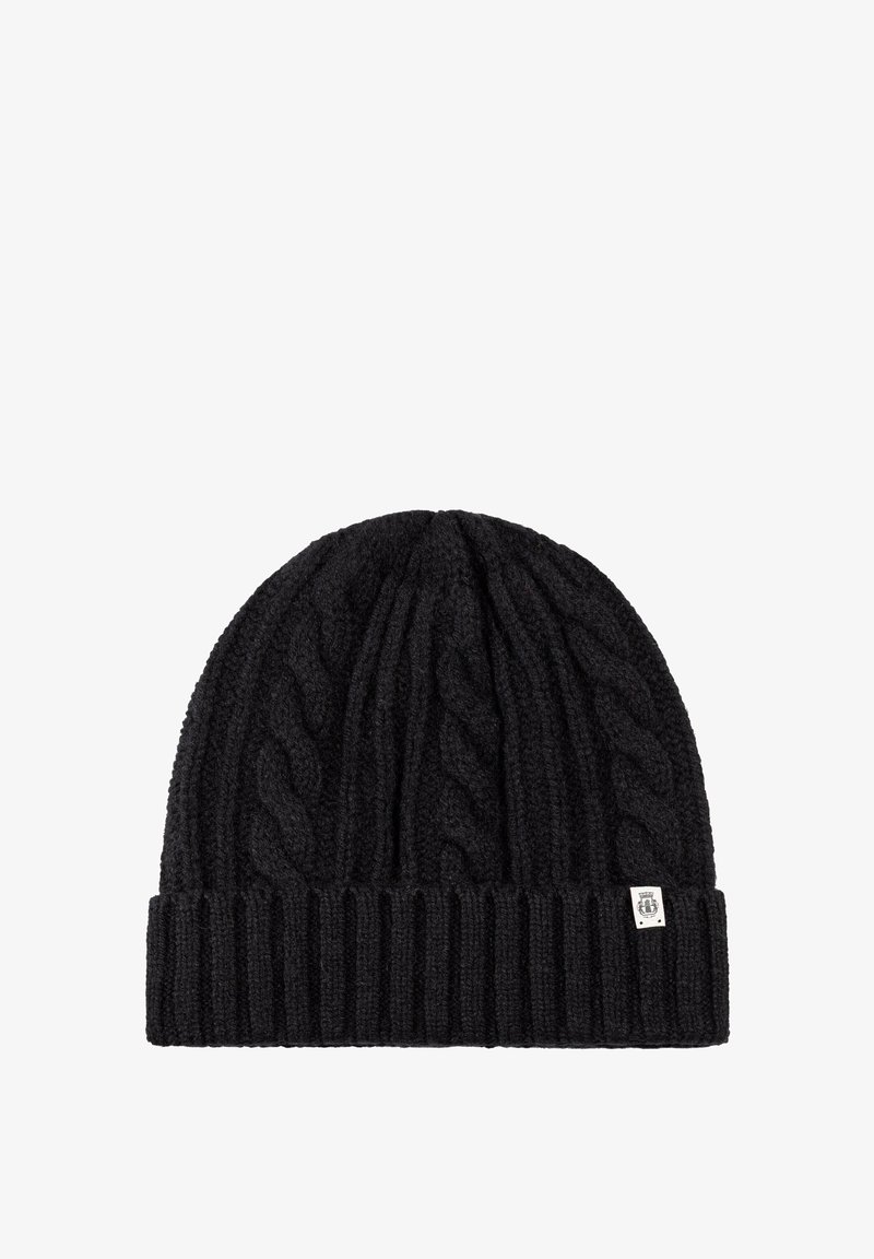 Black knitted beanie with a cable pattern, ribbed cuff, and a small branded tag. Made from textured wool-like material.