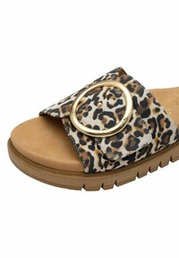 Open-toe sandal with tan footbed, leopard-print strap, and large gold circular buckle on a thick brown sole.