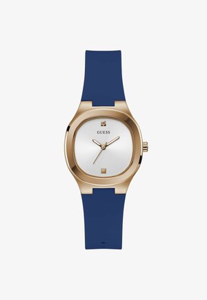 Vierkante horloge met een gouden metalen kast, witte wijzerplaat en blauwe siliconestraps. Voorzien van minimalistische uurmarkeringen en een kleine diamantaccent.