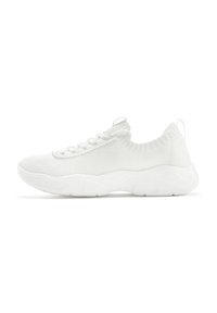 White athletic shoes with a knit upper, textured design, flexible sole, and a pull tab on the heel for easy wear.