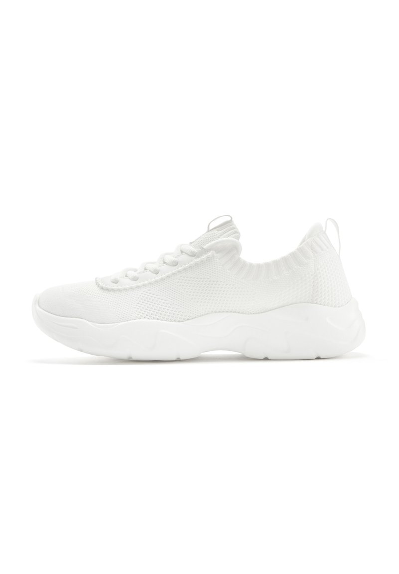 White athletic shoes with a knit upper, textured design, flexible sole, and a pull tab on the heel for easy wear.