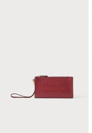 Small rectangular textured burgundy wristlet pouch with gold zipper and embossed text "THE POUCH" on front against neutral background.