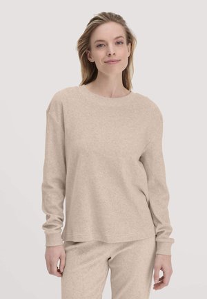 Beige langärmliges Oberteil aus weichem, strukturiertem Stoff. Verfügt über einen runden Ausschnitt und gerippte Bündchen, kombiniert mit passenden Loungewear-Hosen.