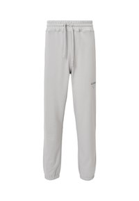 Lichtgrijze training pants met een elastische tailleband, trekkoord en manchetten bij de enkels. Heeft een klein gedrukt logo op het linkerbeen.