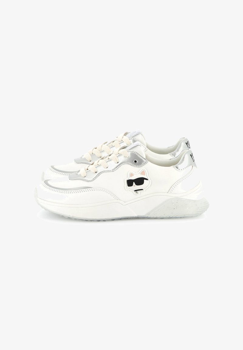 White sneaker with silver accents, featuring a textured sole, lace-up design, and a playful cat graphic on the side.