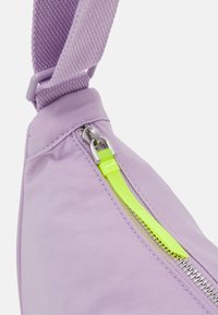 Bolso bandolera de tela morada con cremallera de color amarillo neón y herrajes metálicos. Correa con textura y acabado liso con detalles de costura.