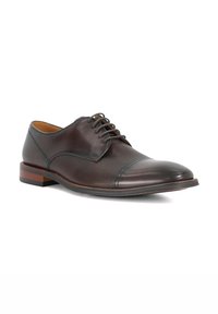 Brown leather dress shoe with a smooth toe cap and textured body. Features six eyelets and a contrasting wooden heel.