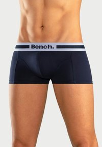 Temno modri bokserice, izdelane iz gladkega materiala, z sivim pasom z logotipom "Bench." in enotnimi šivi.