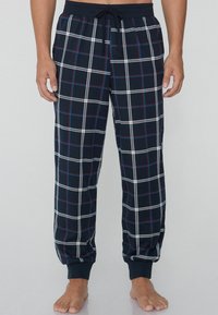 Navyblaue karierte Schlafanzughosen aus weicher Baumwolle, mit weißen und roten Linien, elastischem Bund mit Kordelzug und gerafften Knöcheln.