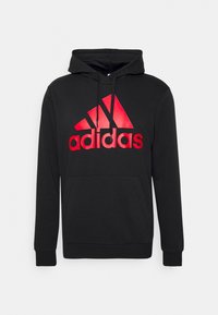 Sweat à capuche noir avec un logo Adidas rouge et des cordons, avec une poche kangourou à l'avant et des manches longues.