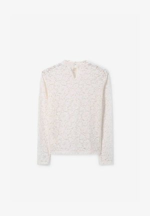 Haut à manches longues en dentelle de couleur blanc cassé avec un motif floral, fermeture à l'arrière en forme de clé, et finition douce et texturée, avec un col rond.