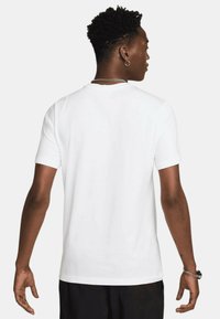 T-shirt bianca a maniche corte realizzata in cotone, con collo rotondo, texture liscia e senza grafiche o motivi visibili.