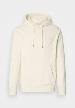 Cream-colored hoodie with a front pocket, drawstring hood, and embossed logo on the chest. Soft fabric with ribbed cuffs and hem.