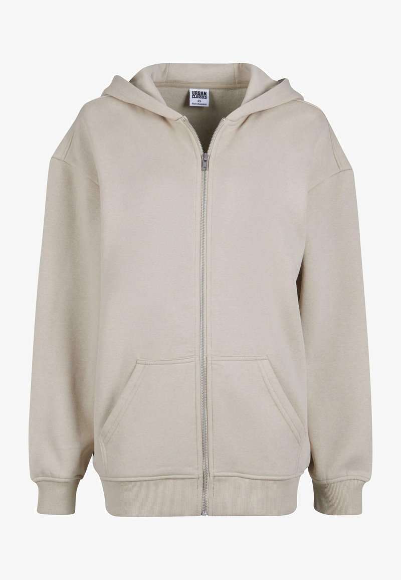 Felpa con zip beige realizzata in tessuto morbido, con cappuccio ampio, due tasche frontali e polsini e orlo a costine.