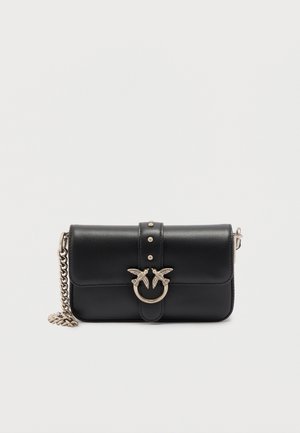 Black leather clutch purse with gold-tone chain strap and decorative metal clasp featuring two birds and stud details.