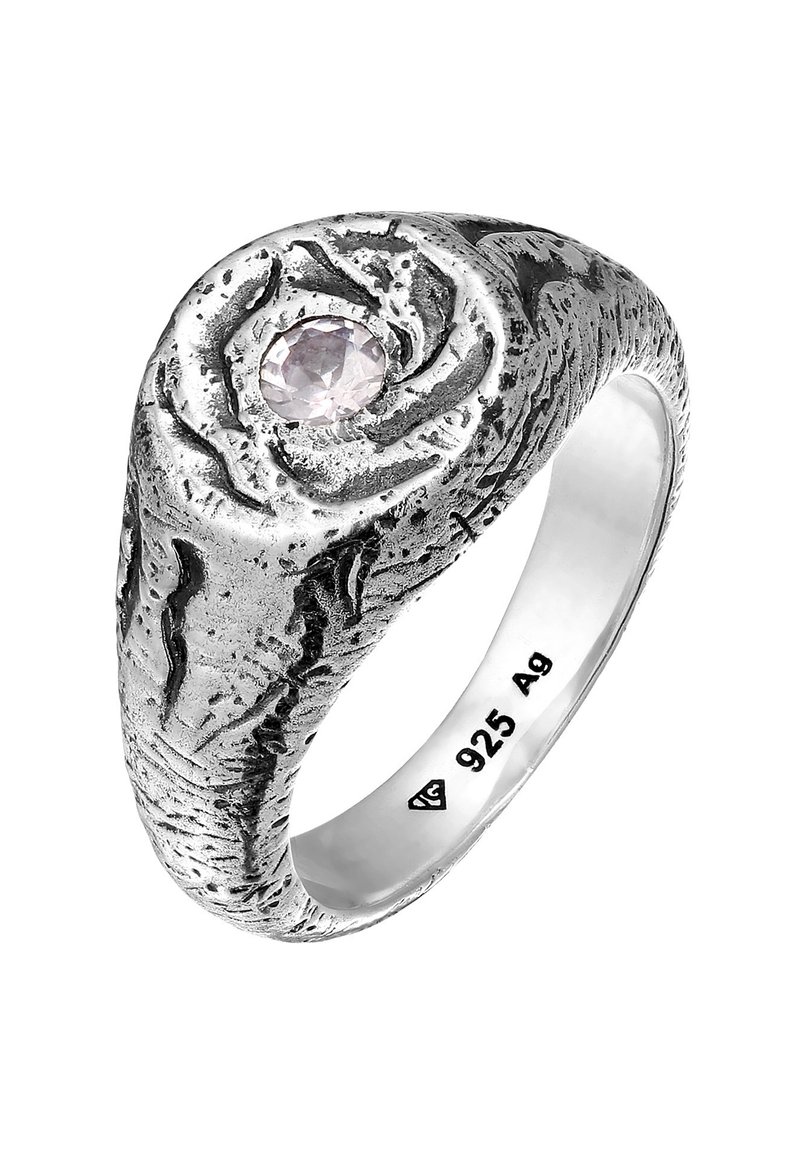 Silverring med texturerad yta, med en central ljusrosa ädelsten. Ringen har en slät band med ingraverat "925" som indikerar sterling silver.
