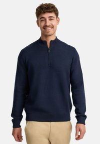 Marineblauer Pullover mit hohem Kragen und kurzem Reißverschluss. Verfügt über gerippte Bündchen und Saum und ist aus einem weichen, glatten Stoff gefertigt.