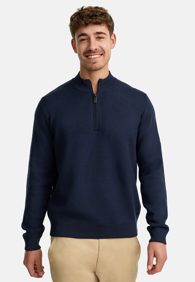 Marineblauer Pullover mit hohem Kragen und kurzem Reißverschluss. Verfügt über gerippte Bündchen und Saum und ist aus einem weichen, glatten Stoff gefertigt.