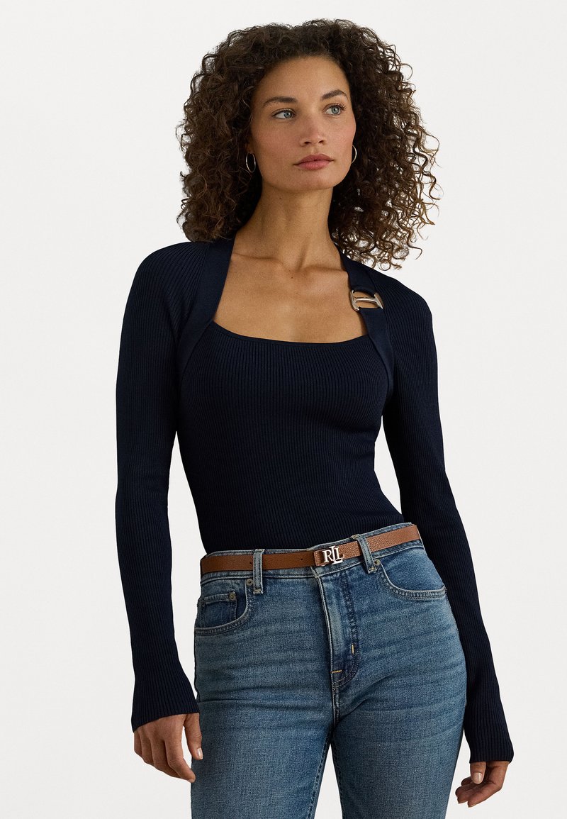 Navy ribbed long-sleeve top featuring a square neckline and a gold buckle accent. Paired with light blue jeans and a brown belt.