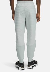 Under Armour UNSTOPPABLE FLEECE GRID - Treningo apatinė dalis - hydro green