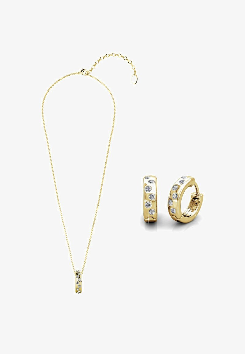 Set di gioielli in oro composto da una delicata collana con catena e pendente, e piccoli orecchini a cerchio decorati con molteplici cristalli trasparenti.