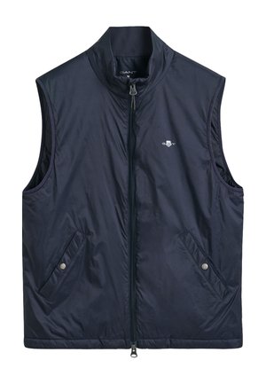 Marineblaue ärmellose Weste mit hohem Kragen, Reißverschluss und zwei schrägen Fronttaschen. Verfügt über dezente Branding auf der Brust. Leichtes Material.
