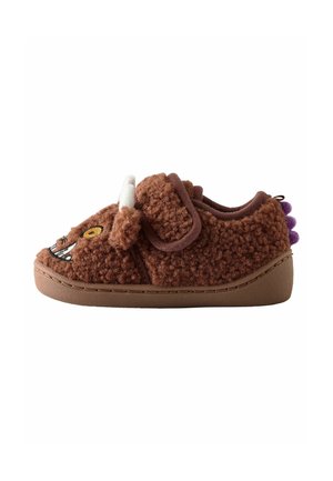 Chaussure pour tout-petit brune et fuzzy avec un visage de monstre, une corne blanche, des piques violettes et une sangle Velcro sur une semelle plate, présentée en profil latéral.