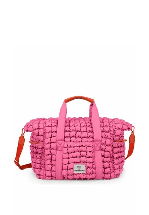 Pink textured padded duffle bag with dual handles, adjustable orange shoulder strap, and a front label reading "UNIO x VISIONNAIRES."