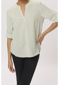 Light green striped blouse with a V-neck, three-quarter sleeves rolled up, and a relaxed fit. Fabric features soft texture and subtle sheen.