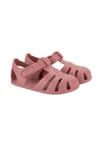 Pink rubber sandals with a closed-toe design, wide straps, and adjustable buckles; features cut-out details and a textured insole.
