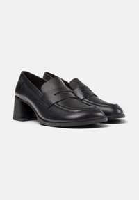 Pair of black leather block heel loafers with rounded toe and decorative strap detail on smooth uppers.