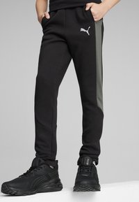 Puma EVOSTRIPE YOUTH - Pantalones deportivos - black
