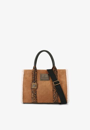 Brown patterned handbag with black handles, textured beige accents, leopard print strap, and a decorative metal tag.