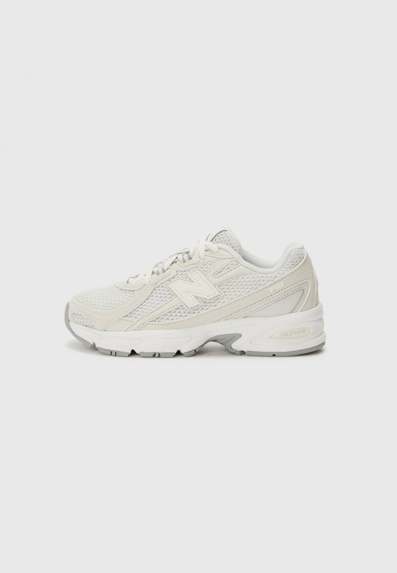 Baskets de sport blanches en maille avec un dessus texturé, un design élégant et une semelle rembourrée avec des accents gris et des détails de marque.