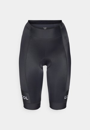 Black cycling shorts made of smooth, stretchy fabric. Features a padded seat area and a logo on the left leg. Mid-thigh length.