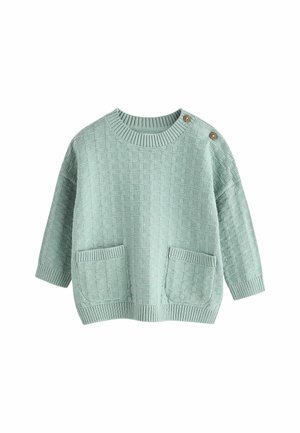 Jasno miętowy dzianinowy sweter z teksturowanym wzorem, ribbowanym dekoltem i mankietami. Posiada dwie przednie kieszenie oraz detal z guzikami na ramieniu.