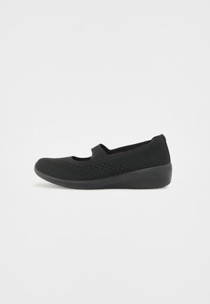 Black slip-on shoes with a breathable knit upper, round toe, and elastic gore on the sides. Features a textured sole for traction.